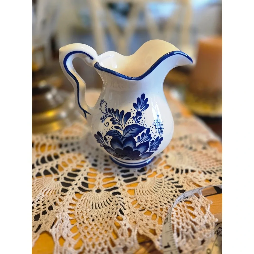 This is a vintage Delft Blue hand-painted ceramic creamer pitcher And Bowl/plate